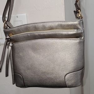 Pewter crossbody. Lots of zipper pockets.